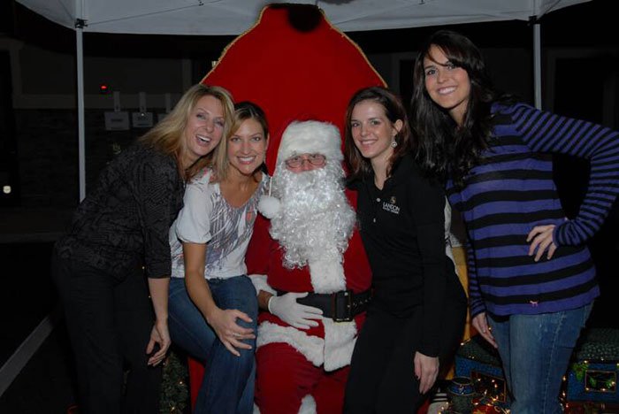 red carpet event four women posing with santa