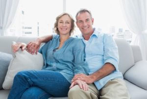 Tampa O-Shot couples sitting on a light gray couch