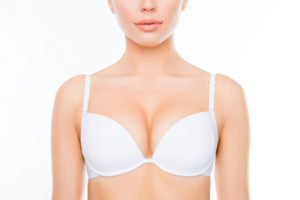 Tampa Breast Augmentation model wearing a white bra