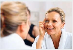 Tampa Anti-Aging PRP Injections model evaluating her skin in the mirror