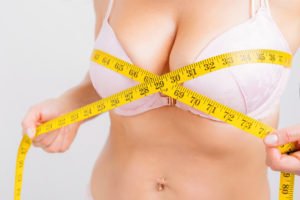 Tampa Breast Augmentation model measuring her breast