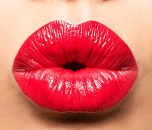 Tampa Injectables model close-up of her red plump lips.