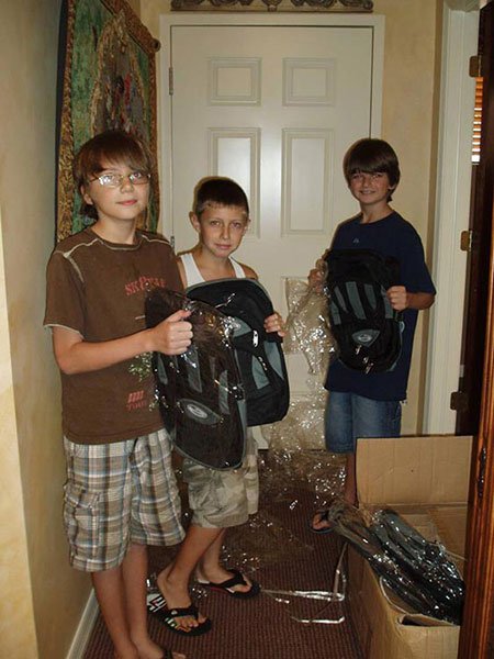 three boys with backpacks